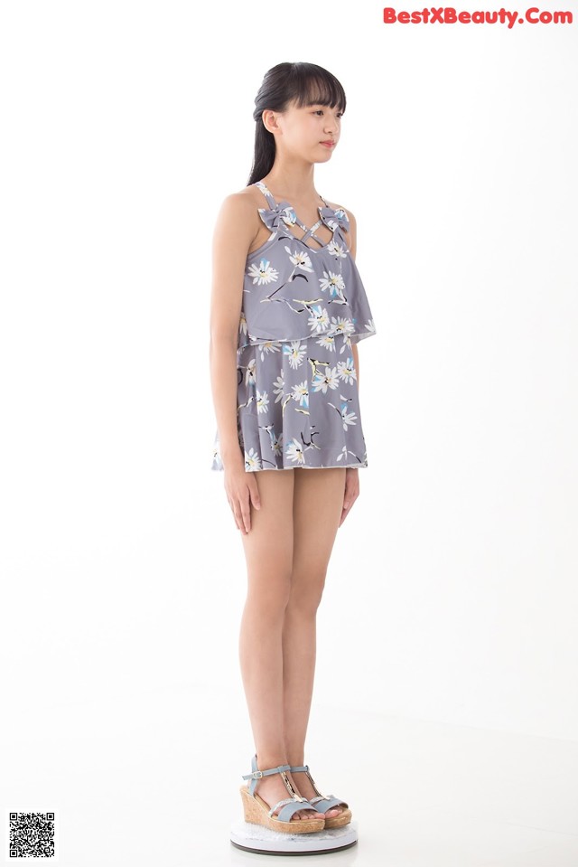a woman standing in front of a white background
