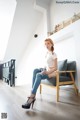 A woman sitting on a chair in a room.