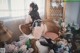 A woman sitting on a chair in a room with flowers.