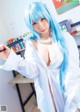 A woman with blue hair holding a baseball bat.